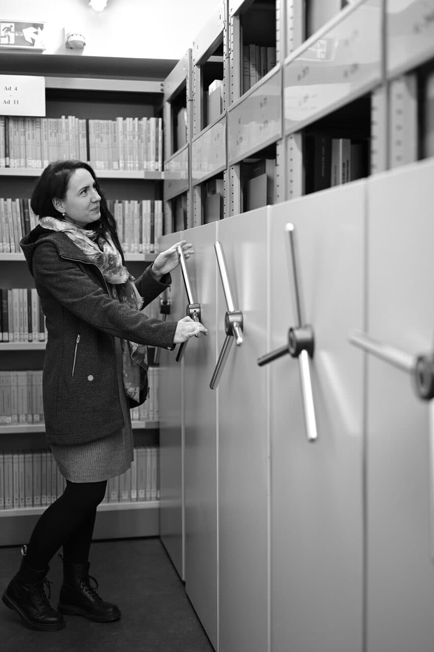 Inside an Archive: Aneta Plzáková at the moving storage rack shelves Inside an Archive: Aneta Plzáková at the moving storage rack shelves